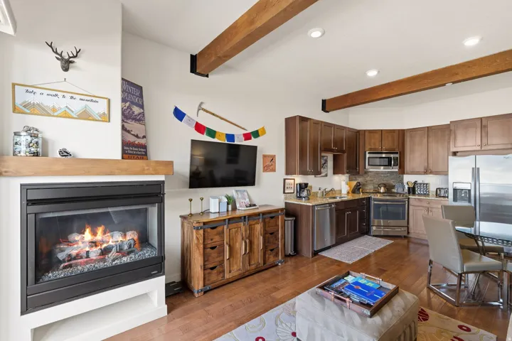 Kitchen with backsplash, stainless steel appliances, recessed lighting, dark wood-style flooring, and beam ceiling