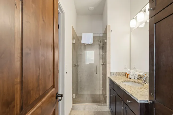 Bathroom featuring vanity and a shower stall
