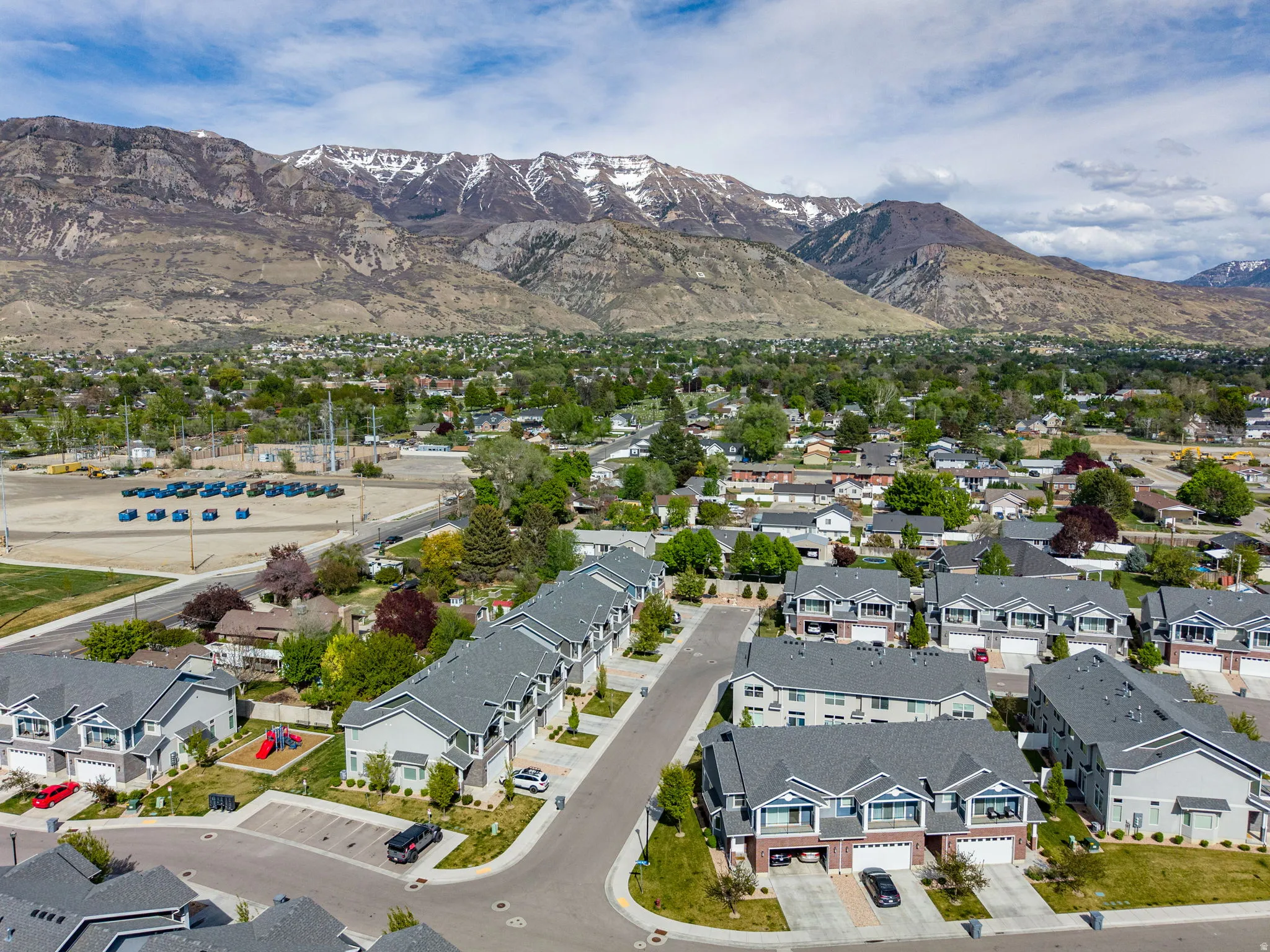 Aerial perspective of suburban area with a mountainous background