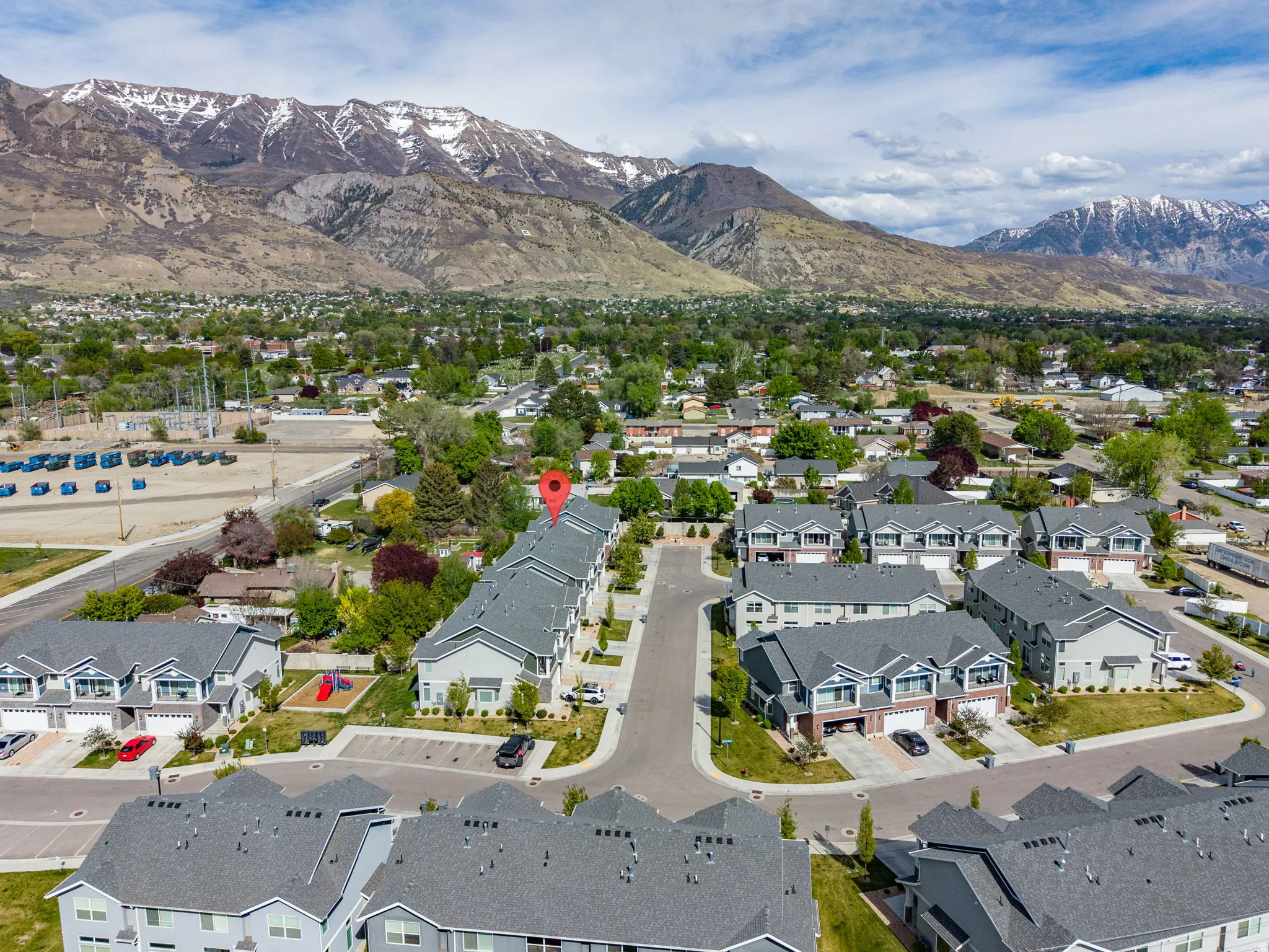 Aerial perspective of suburban area featuring a mountainous background