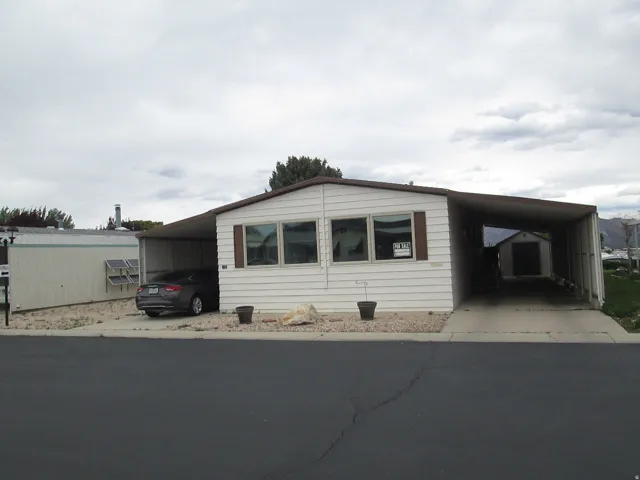 View of front of home featuring two carports.