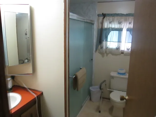 Bathroom featuring a shower stall and vanity
