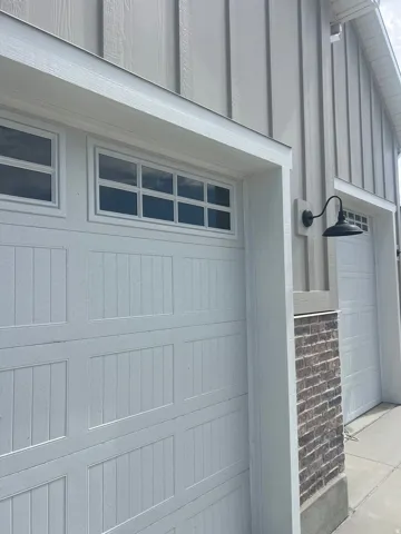 White paneled garage doors with upper window inserts