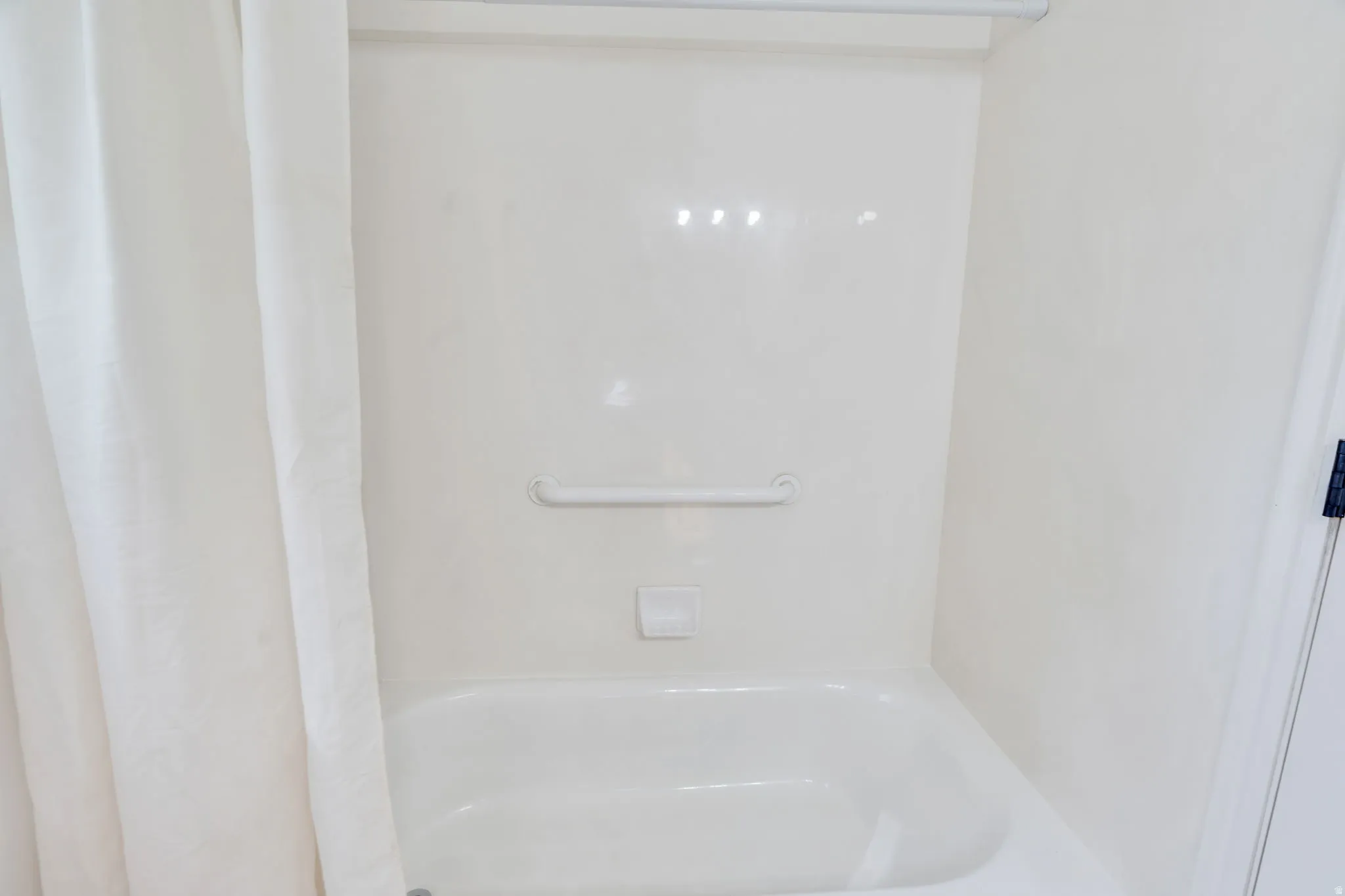 Bathroom with shower / bath combination with curtain