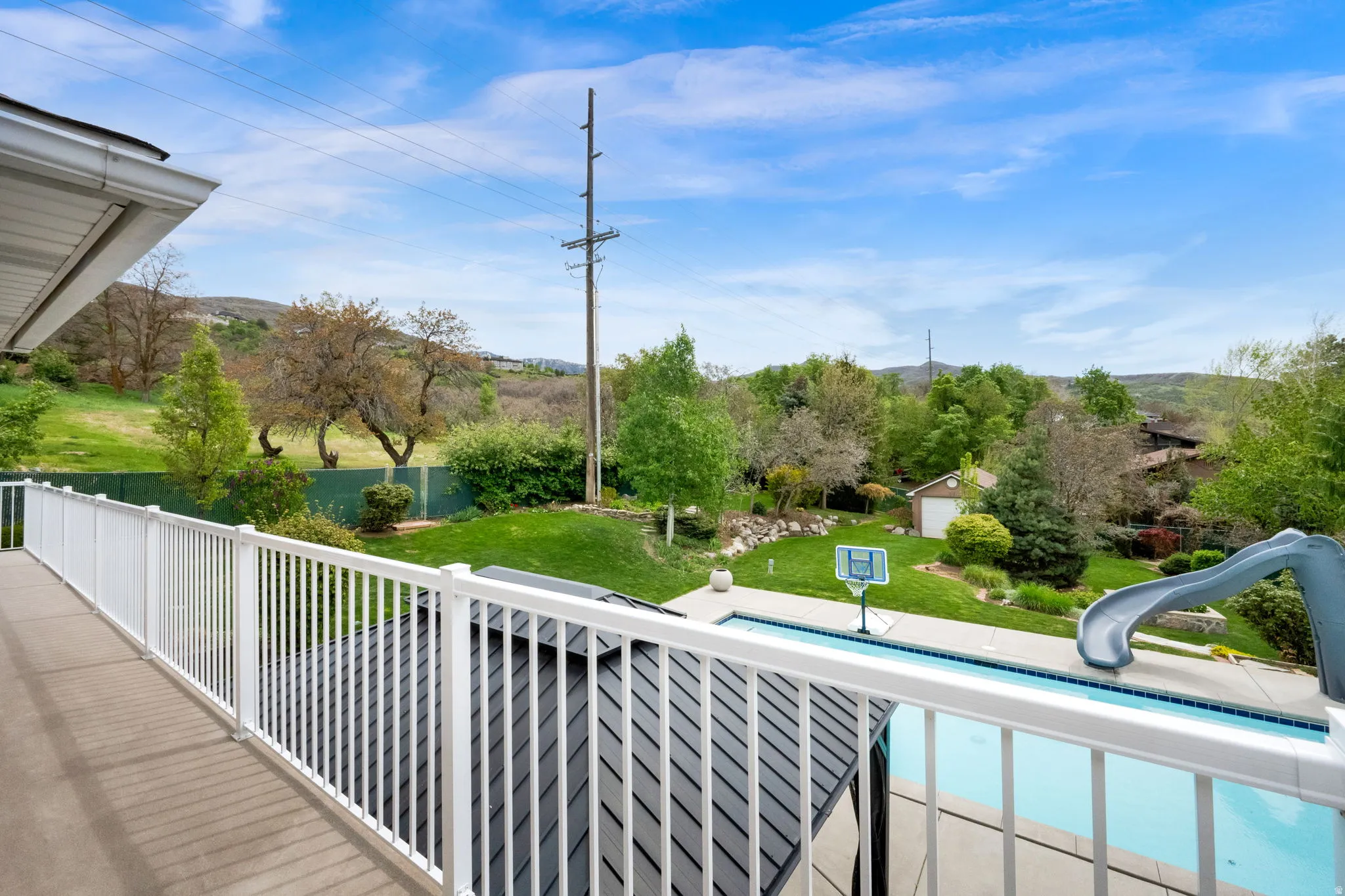 Balcony featuring view of pool area