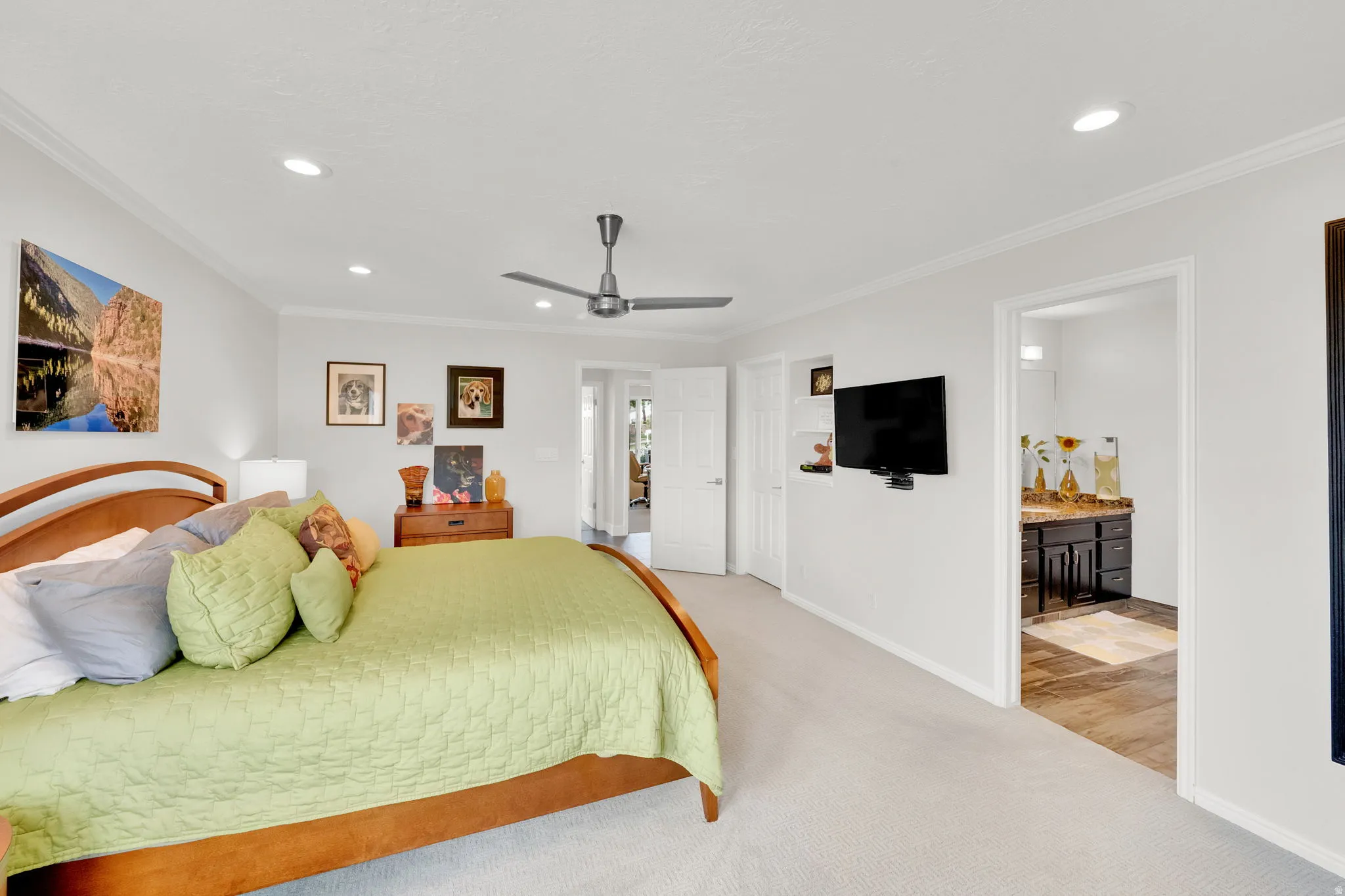 Master Bedroom featuring light colored carpet, recessed lighting, crown molding, ensuite bathroom, and ceiling fan