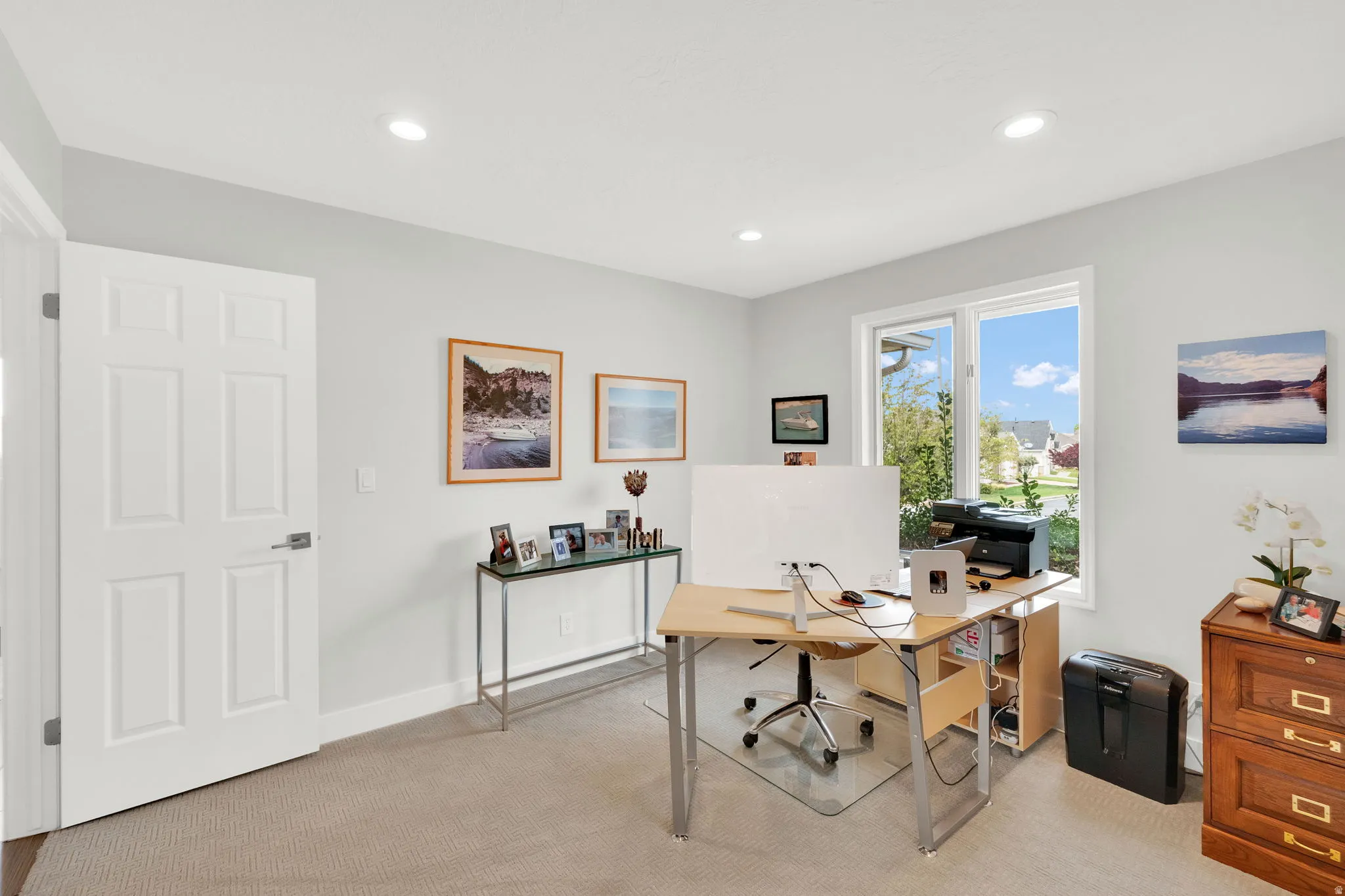 Office with light carpet and recessed lighting