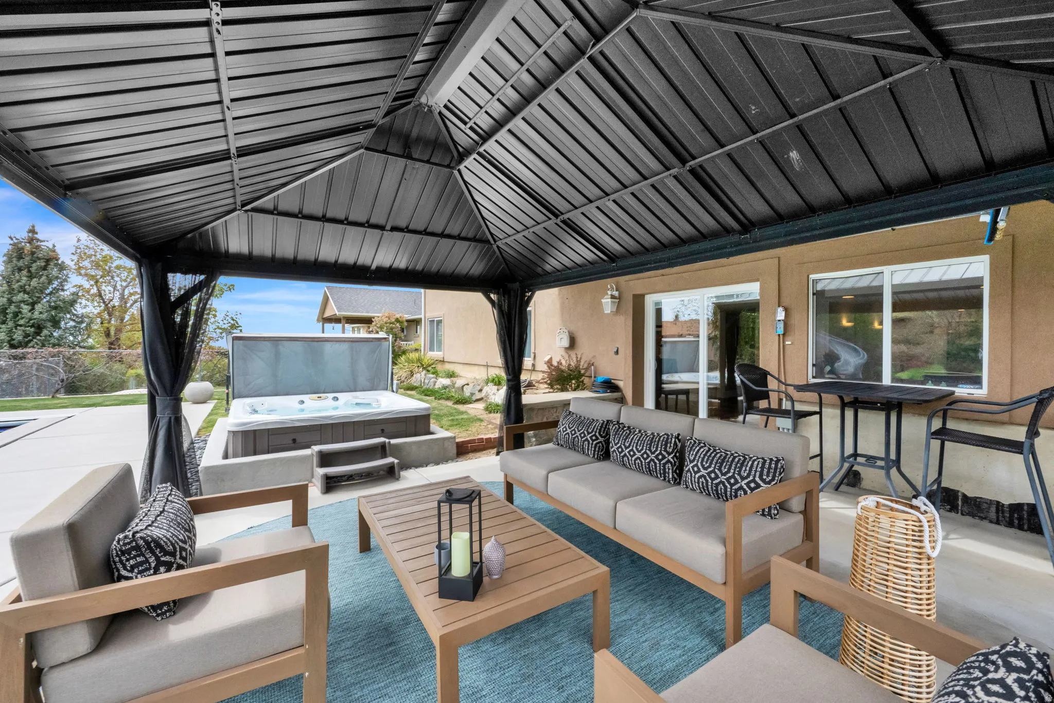 View of patio with an outdoor living space and a hot tub