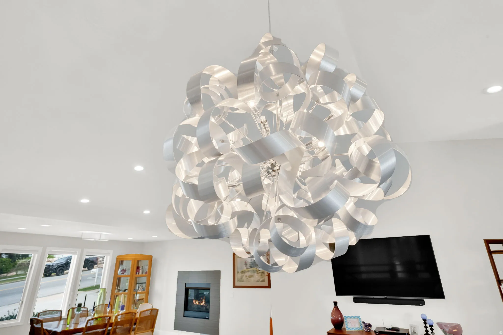 Detailed view of recessed lighting and a glass covered fireplace
