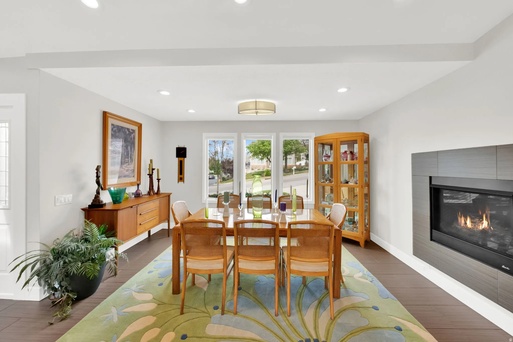 Dining room featuring tile flooring, a fireplace, and recessed lighting