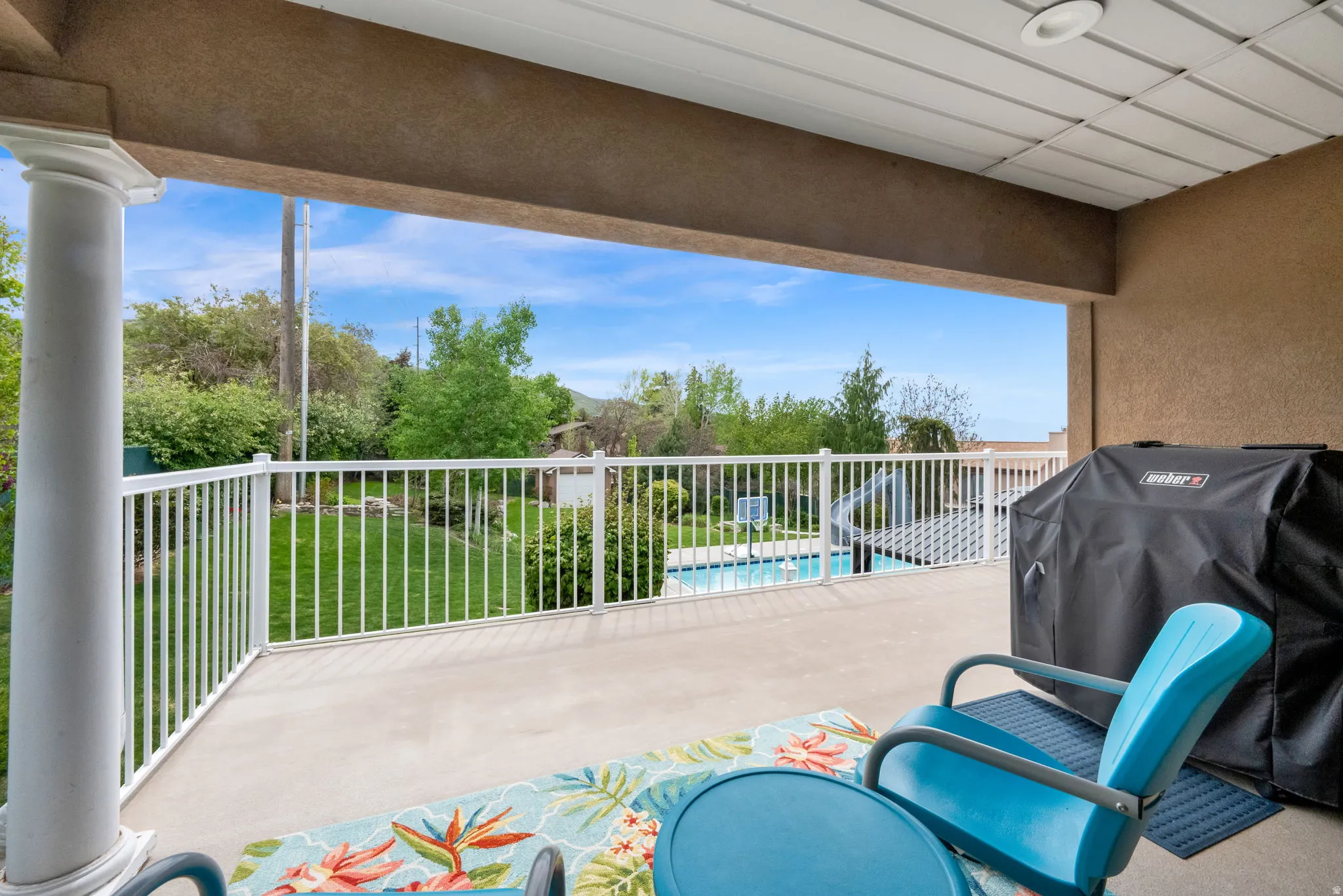 View of patio with a grill