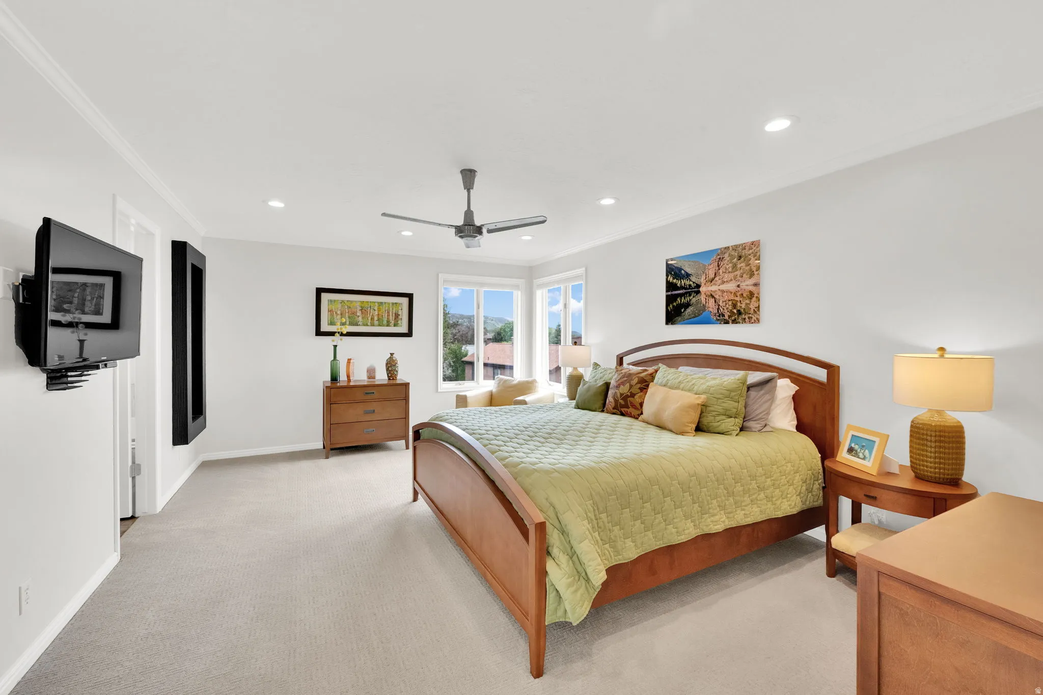 Master Bedroom with crown molding, recessed lighting, light colored carpet, and ceiling fan