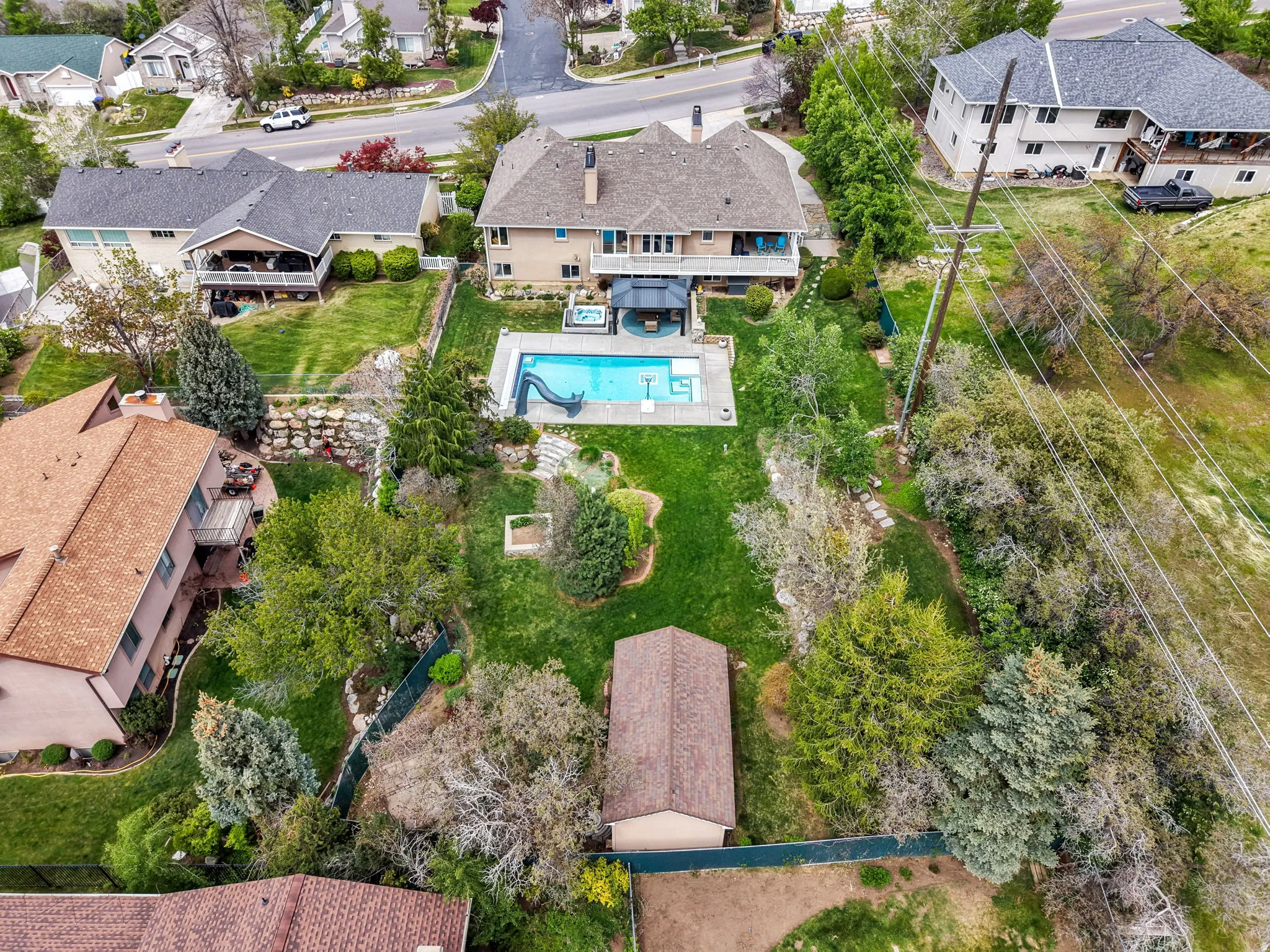 Aerial perspective of suburban area featuring a pool