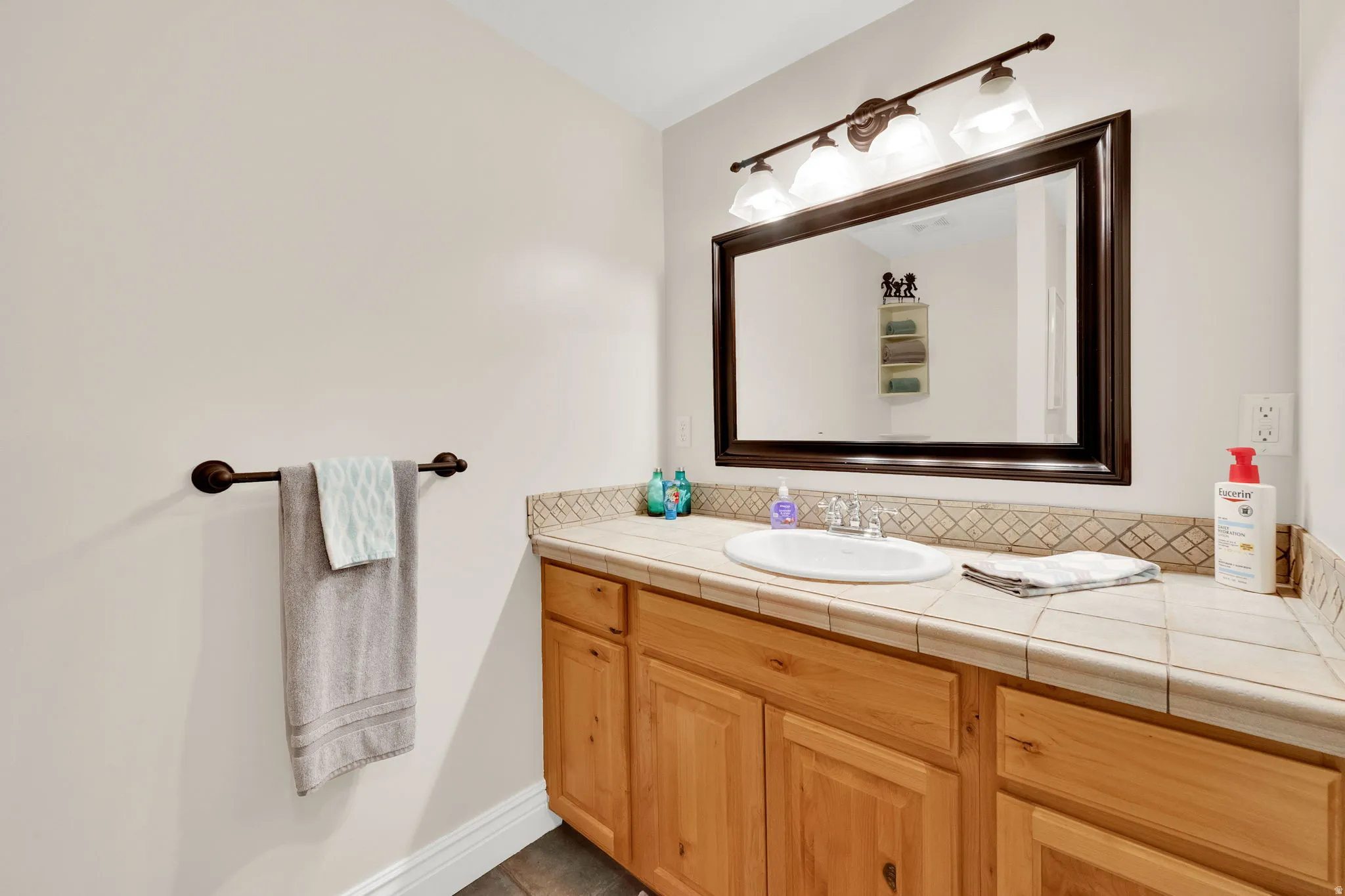 Bathroom featuring vanity and baseboards