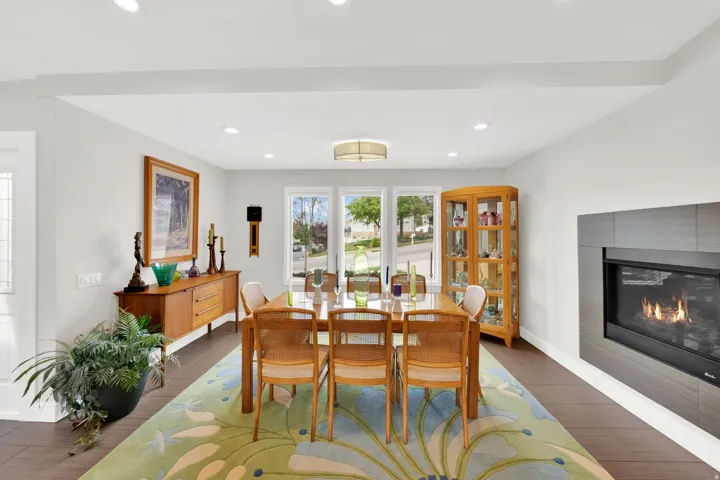 Dining room featuring tile flooring, a fireplace, and recessed lighting