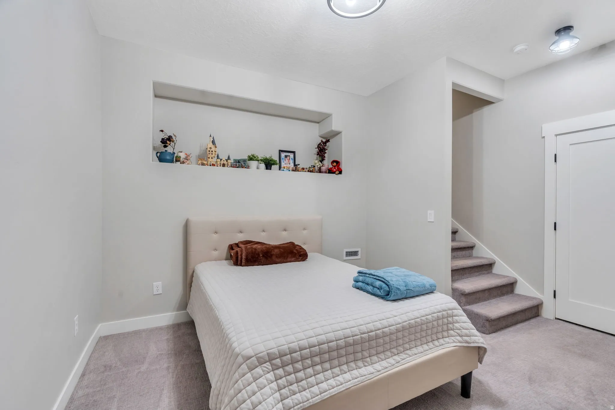Bedroom with light colored carpet