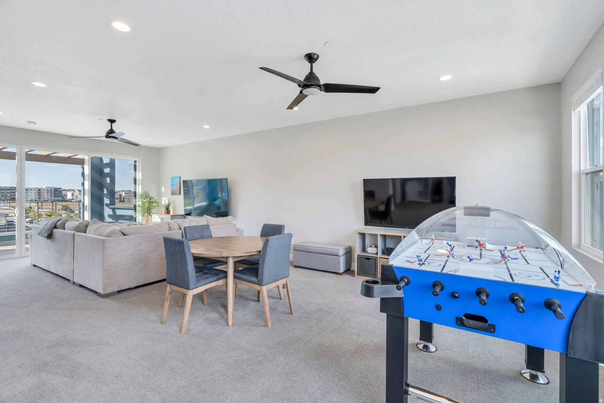 Playroom featuring plenty of natural light, a ceiling fan, light colored carpet, and recessed lighting