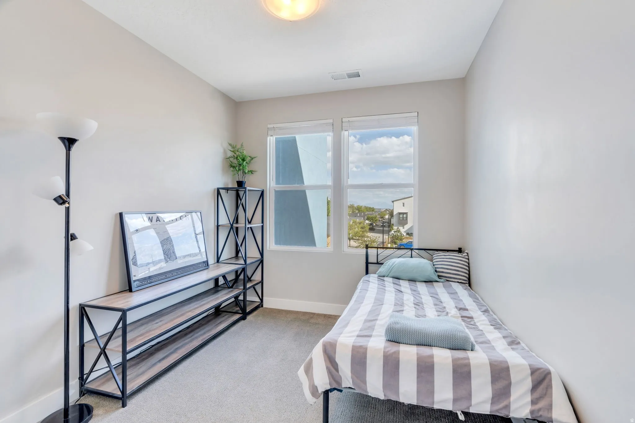Bedroom with light carpet and baseboards
