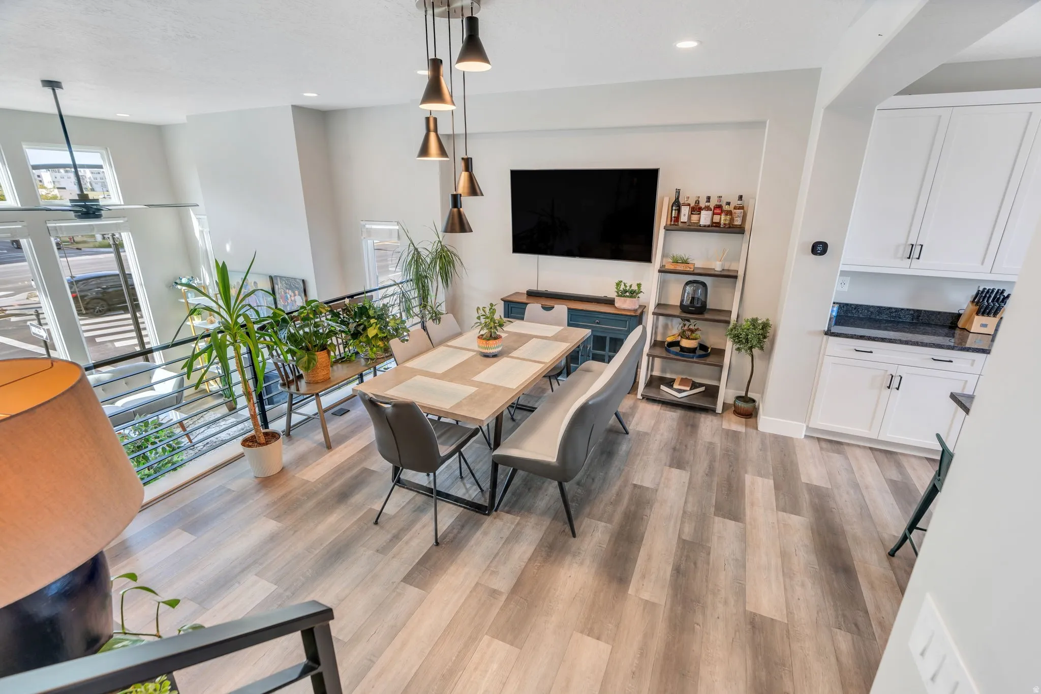 Dining area with light wood-style flooring and recessed lighting