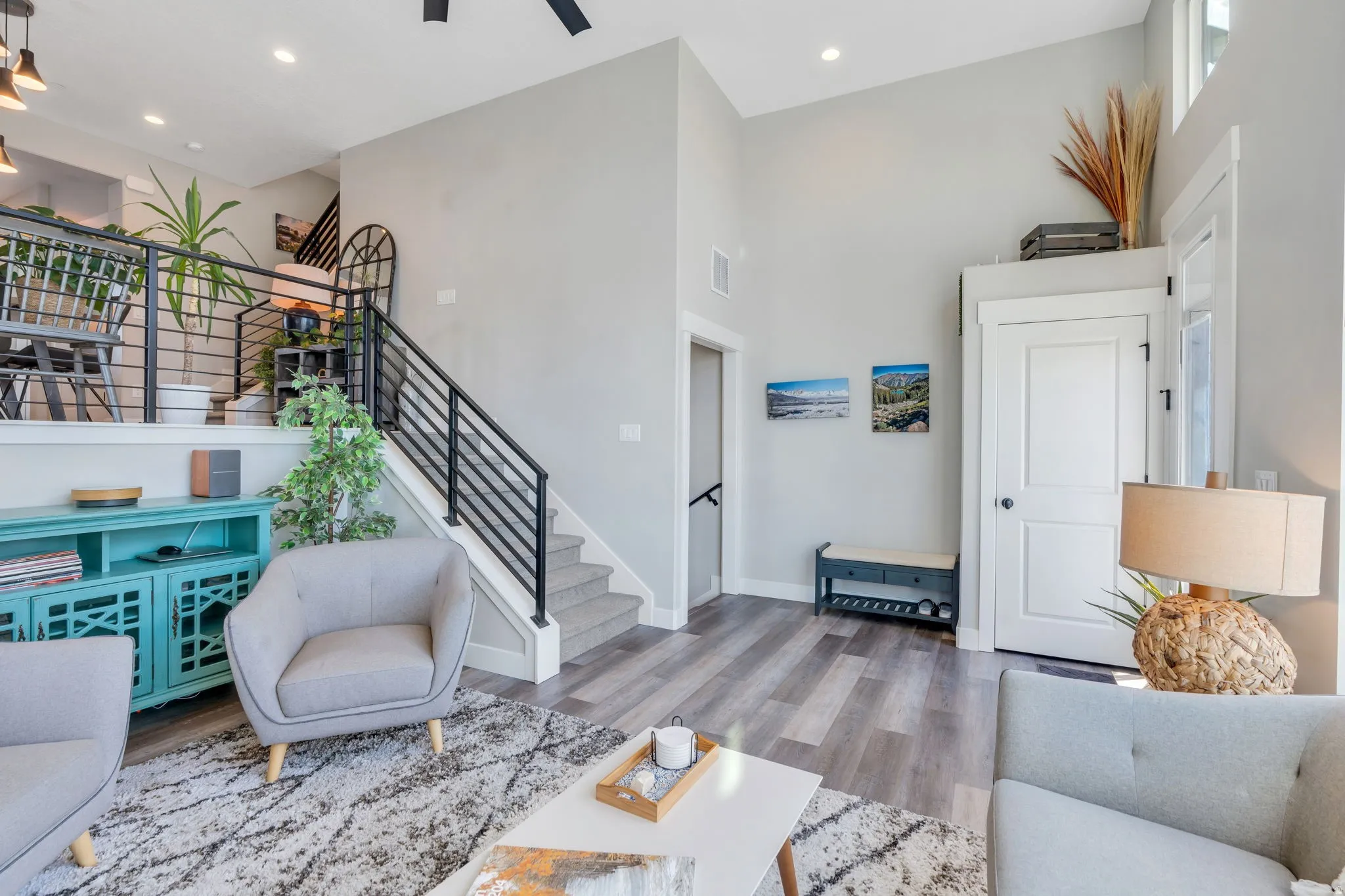 Living room featuring a high ceiling, light wood-style floors, recessed lighting, and ceiling fan