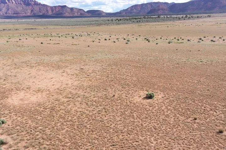 View of mountain backdrop with a desert landscape and rural landscape