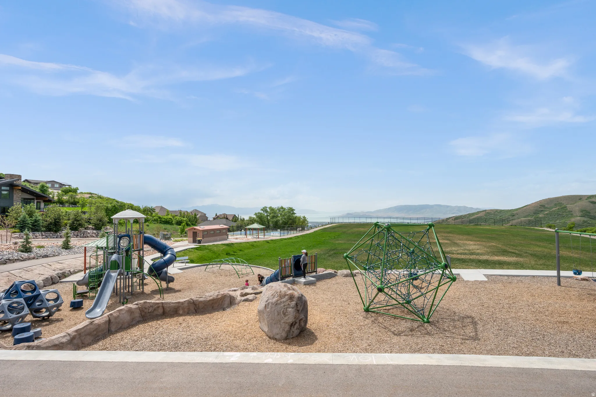 Communal playground with a lawn and a mountain view