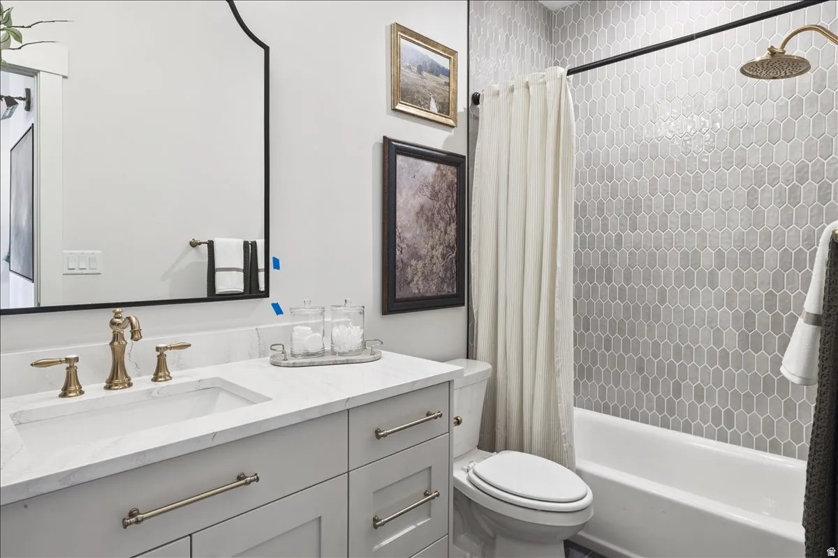 Full bathroom featuring vanity and shower / bath combination with curtain