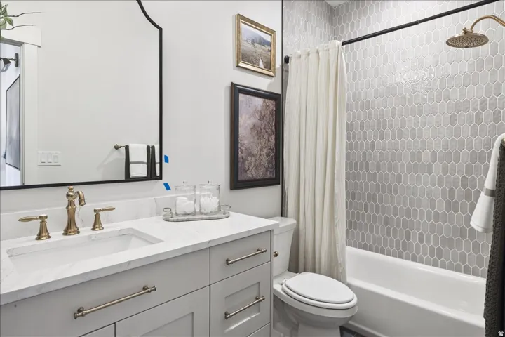 Full bathroom featuring vanity and shower / bath combination with curtain