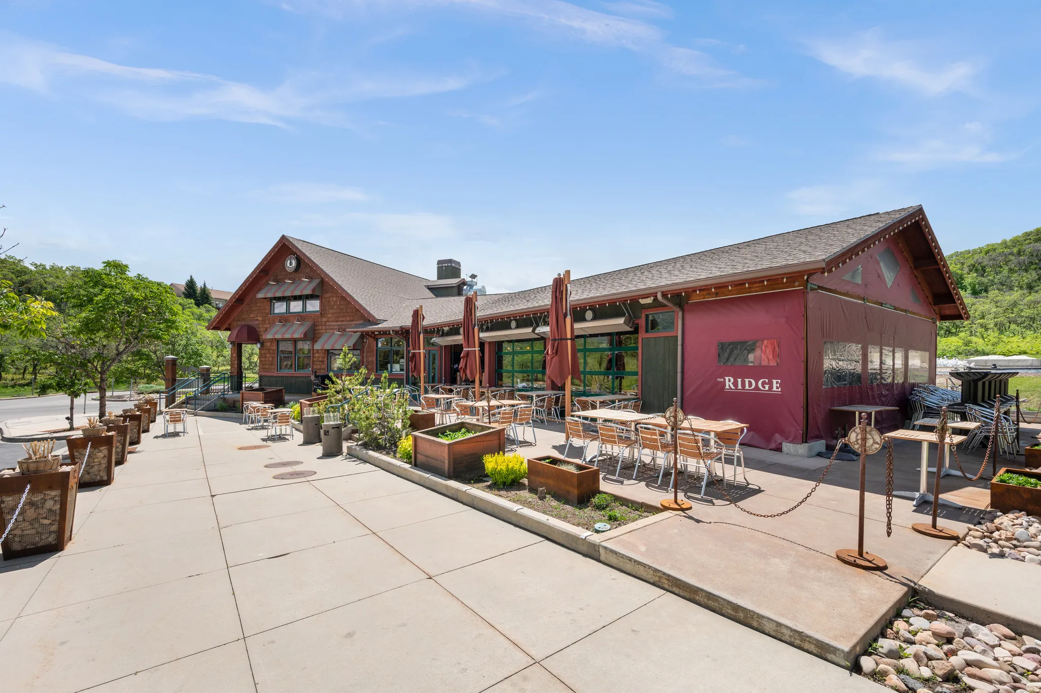 View of home's community with outdoor dining area and a patio