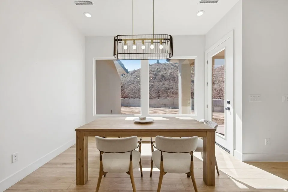 Dining area with light wood-style flooring, a mountain view, and recessed lighting