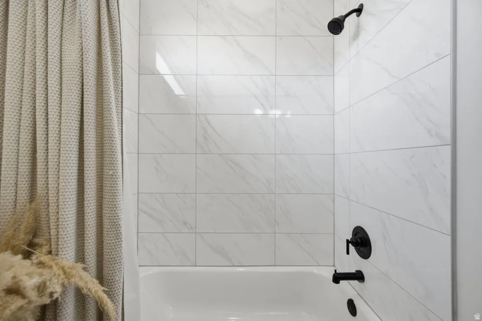 Full bathroom with shower / tub combo with curtain