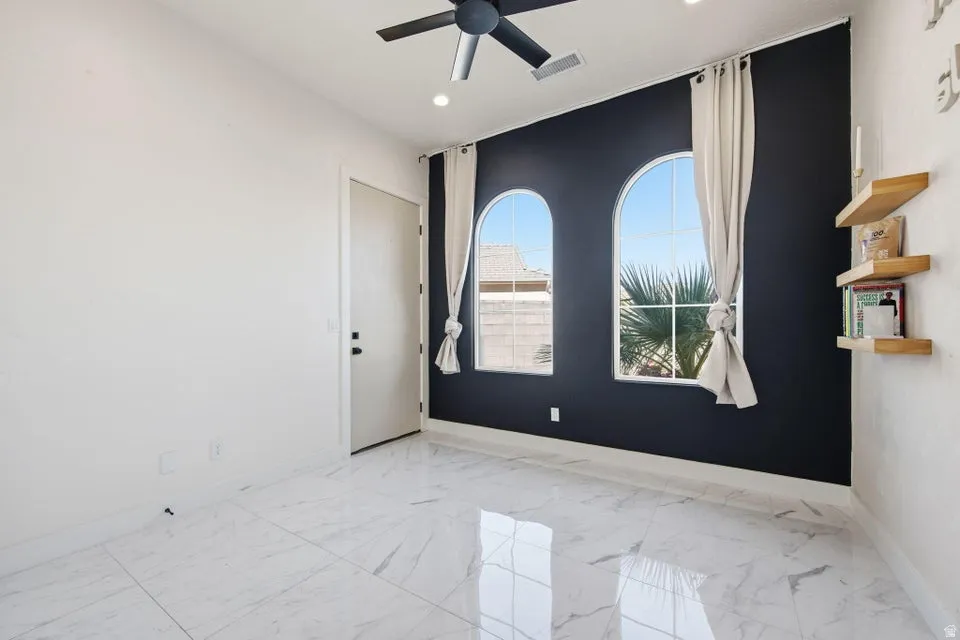 Unfurnished room with ceiling fan, light marble finish floors, and recessed lighting