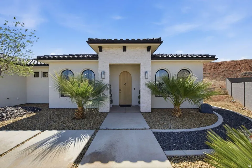 Mediterranean / spanish home with stucco siding and a tiled roof