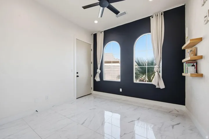 Unfurnished room with ceiling fan, light marble finish floors, and recessed lighting