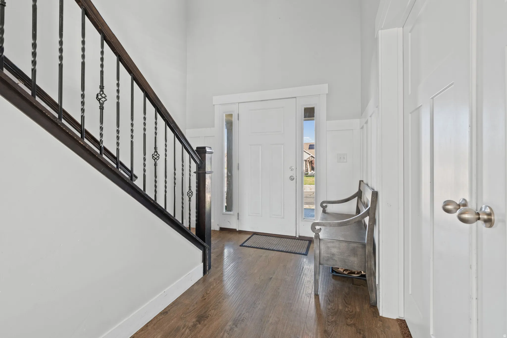 Foyer featuring dark wood-type flooring and a high ceiling