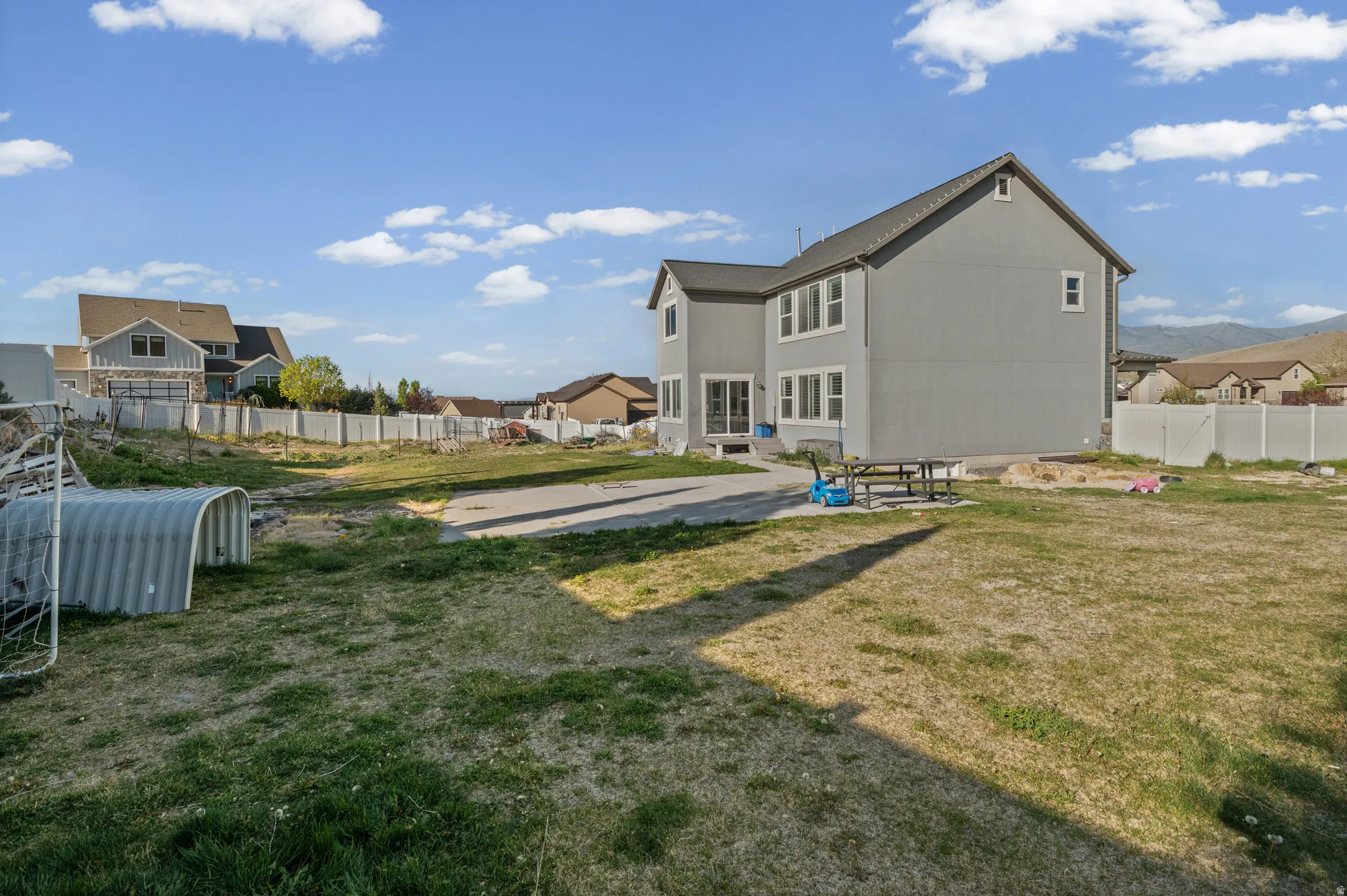 Rear view of property featuring a patio area, a fenced backyard, and a mountain view