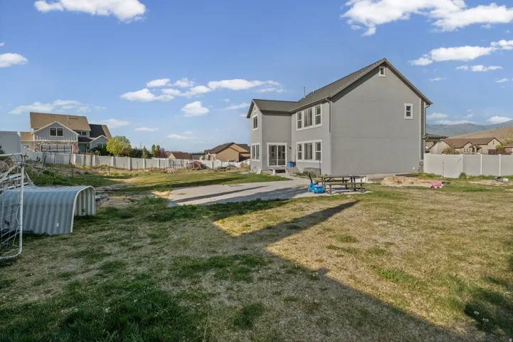 Rear view of property featuring a patio area, a fenced backyard, and a mountain view