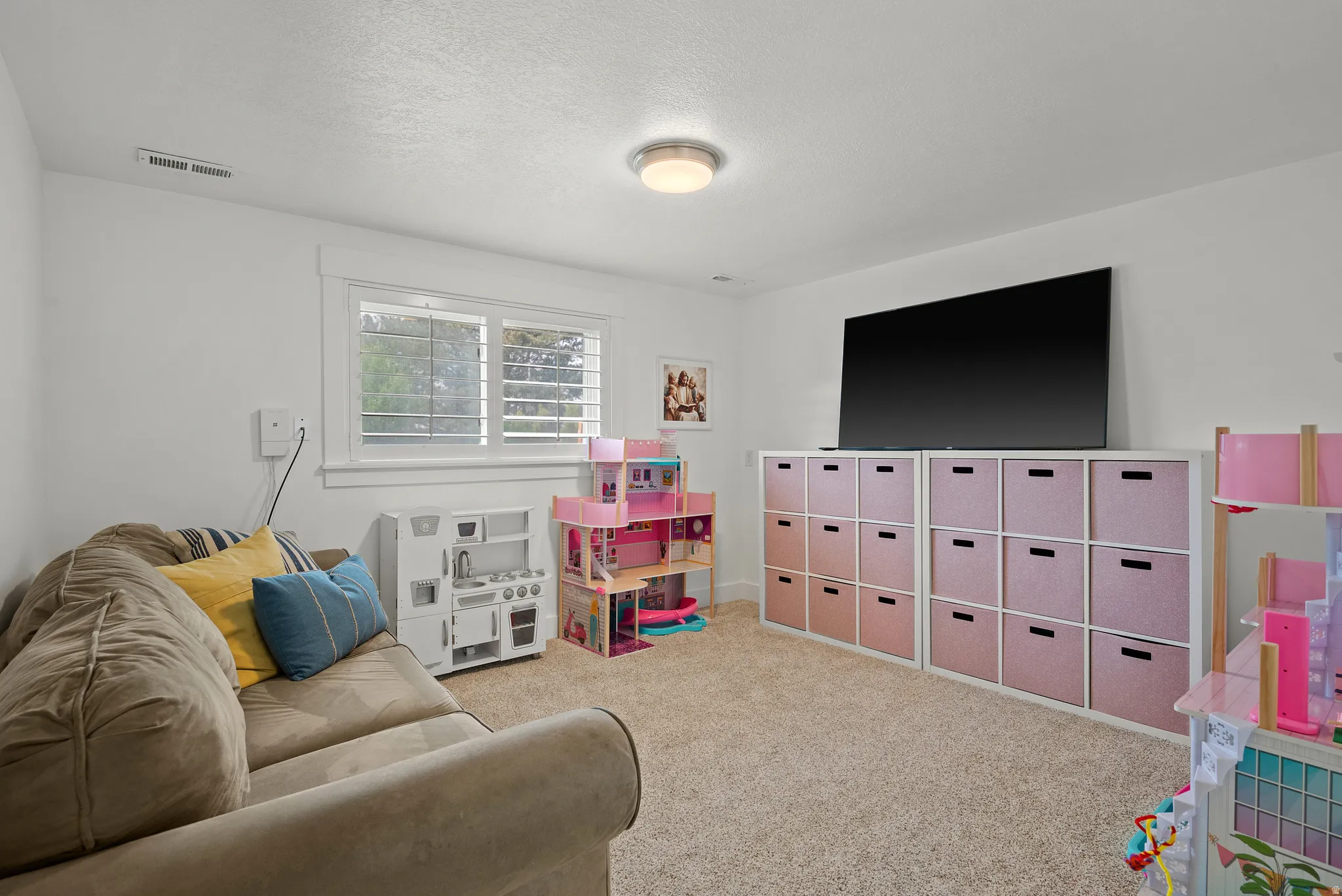 Game room featuring carpet flooring and a textured ceiling