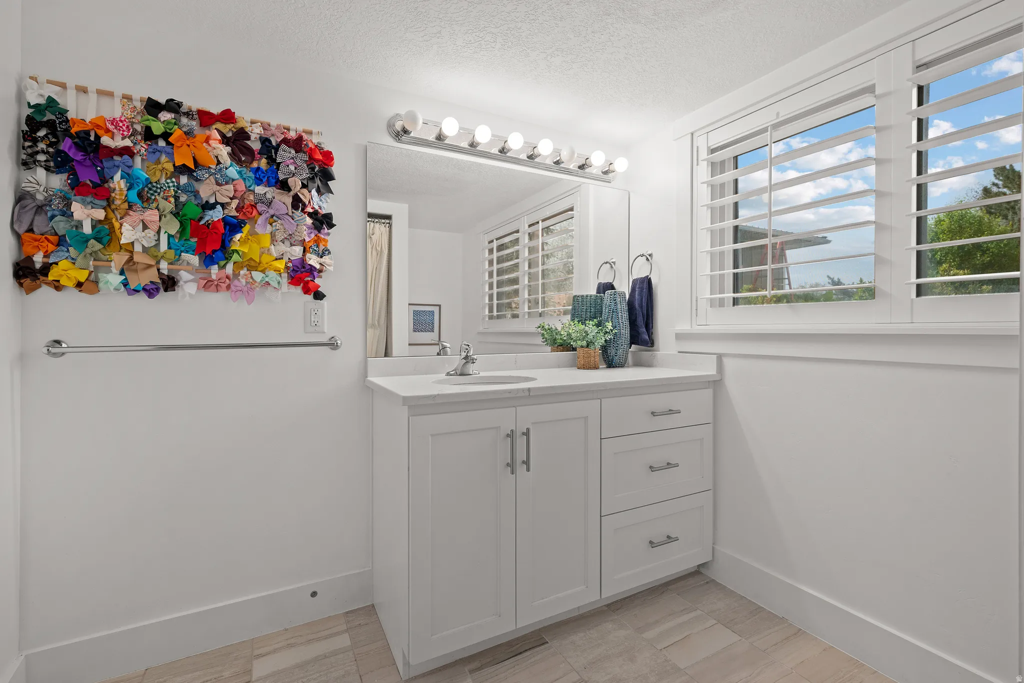 Bathroom with vanity and a textured ceiling