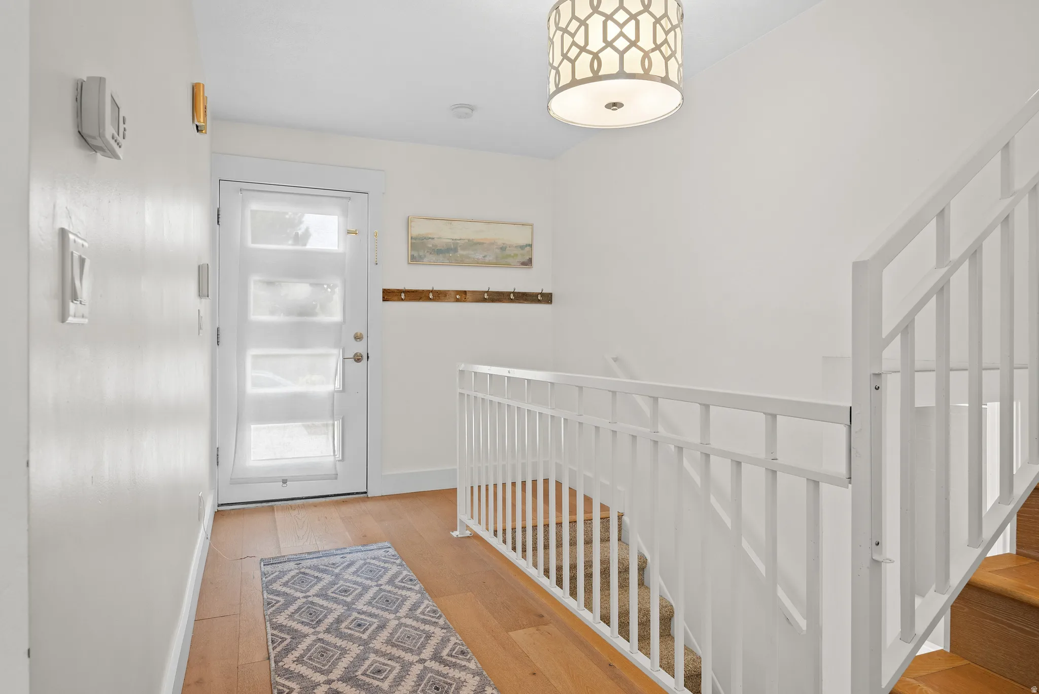 Entryway featuring hardwood / wood-style floors and baseboards