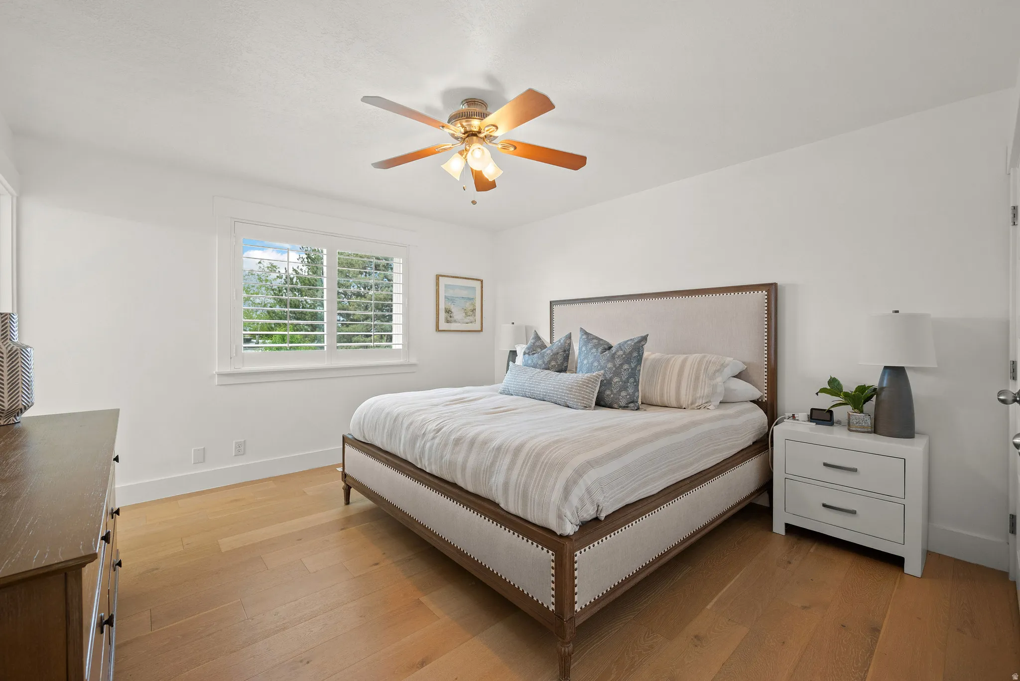 Bedroom featuring light wood-type flooring and ceiling fan