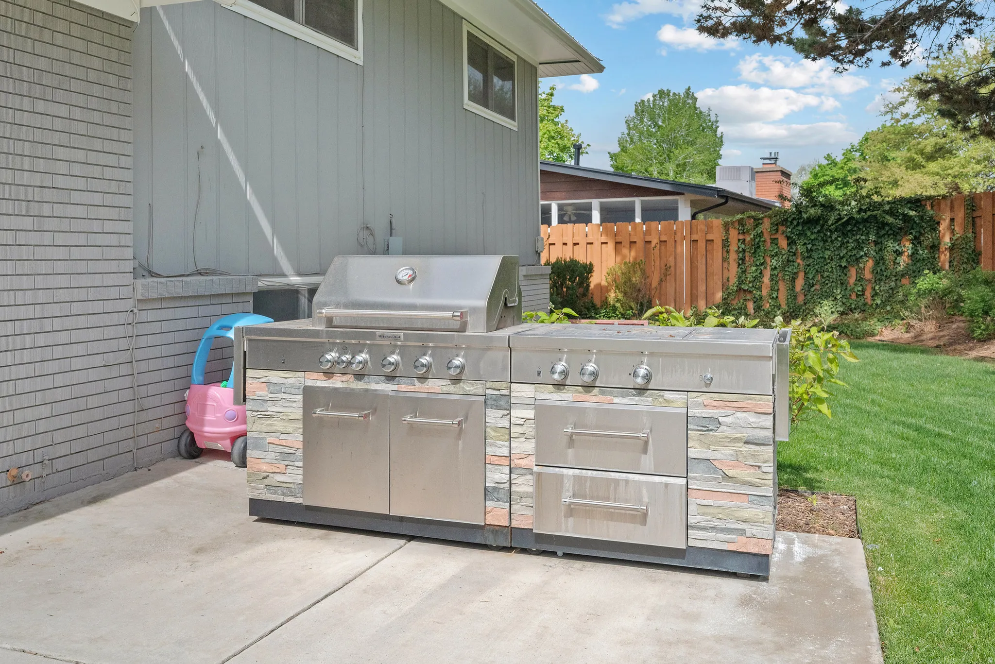 View of patio featuring exterior kitchen