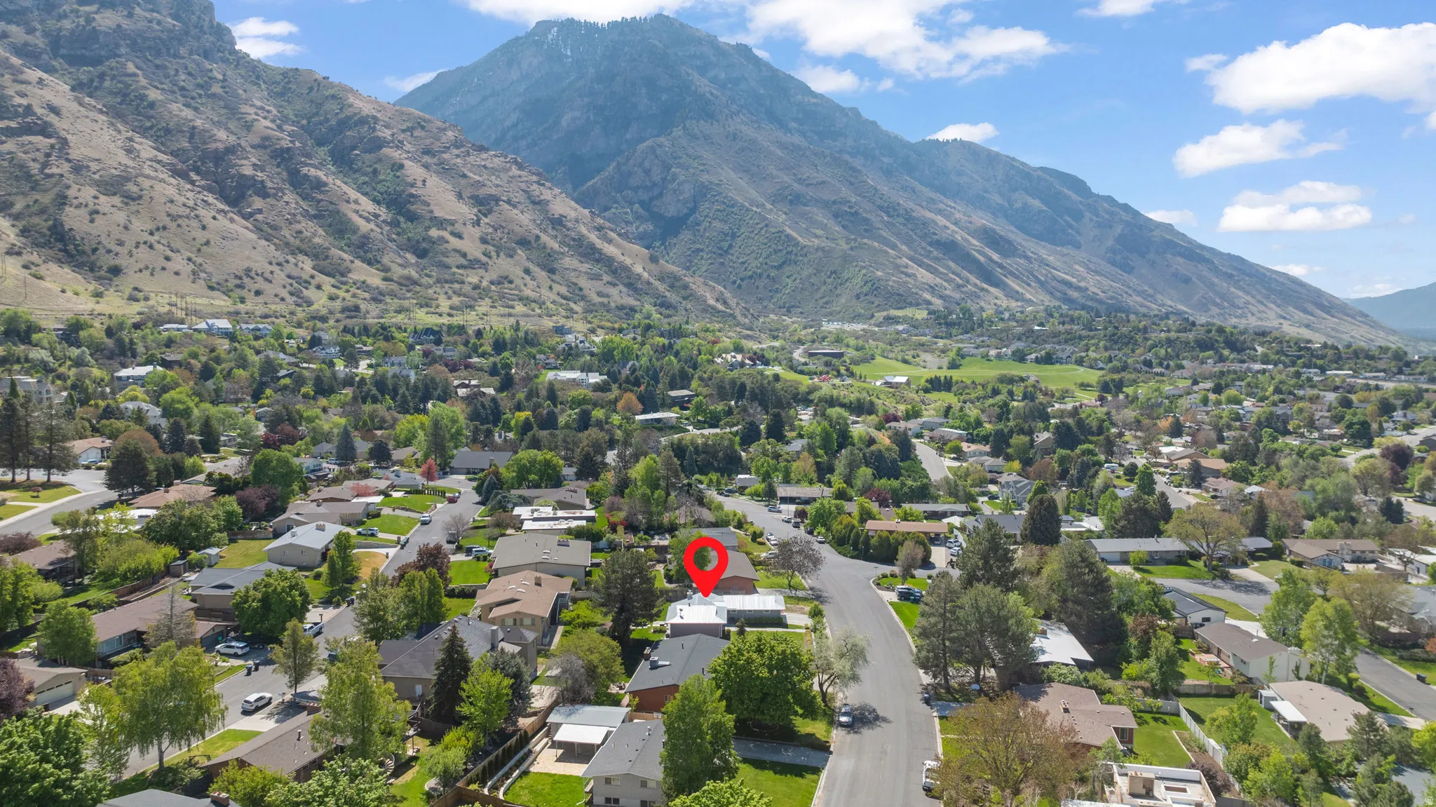 Aerial perspective of suburban area with a mountainous background