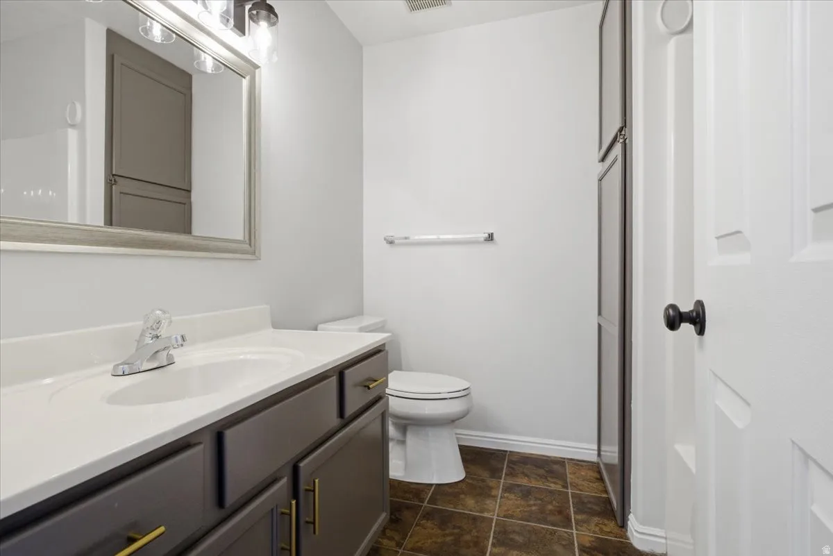 Full bath with toilet and vanity