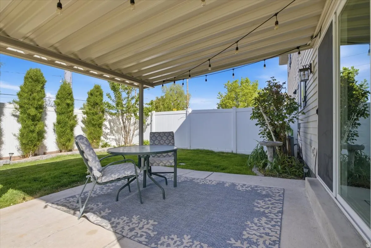 Fenced backyard with a patio and outdoor dining space