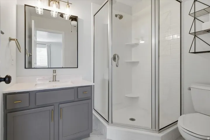 Bathroom with vanity and a stall shower