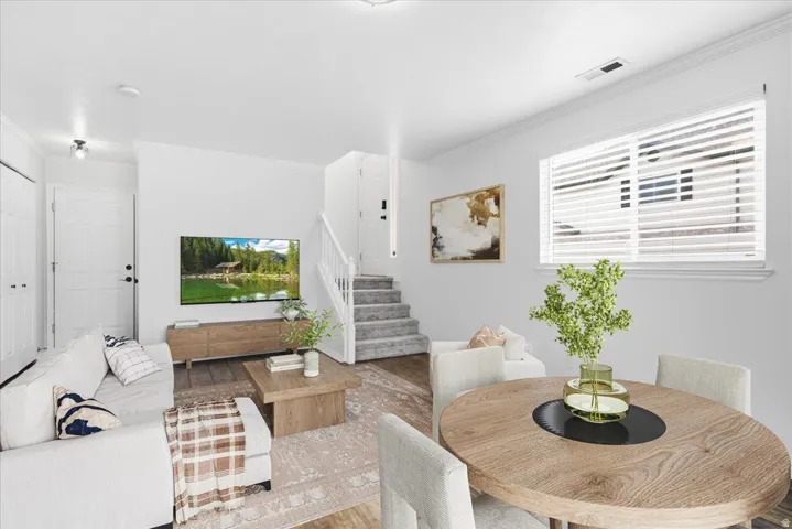 Dining space with crown molding and wood finished floors