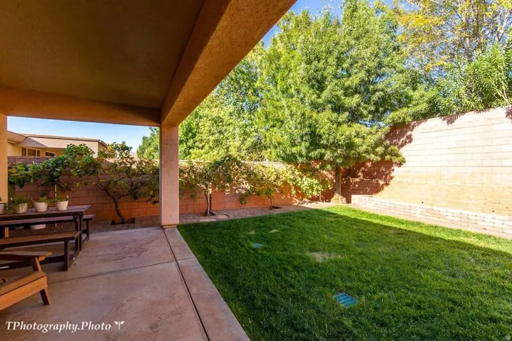 Fenced backyard with a patio area