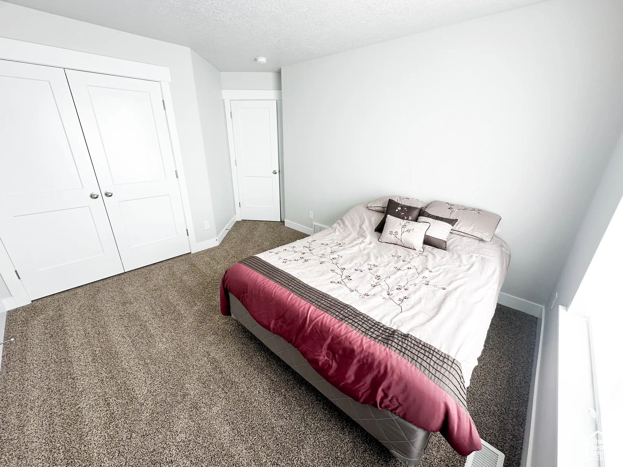 Plush carpet flooring complements bright white walls