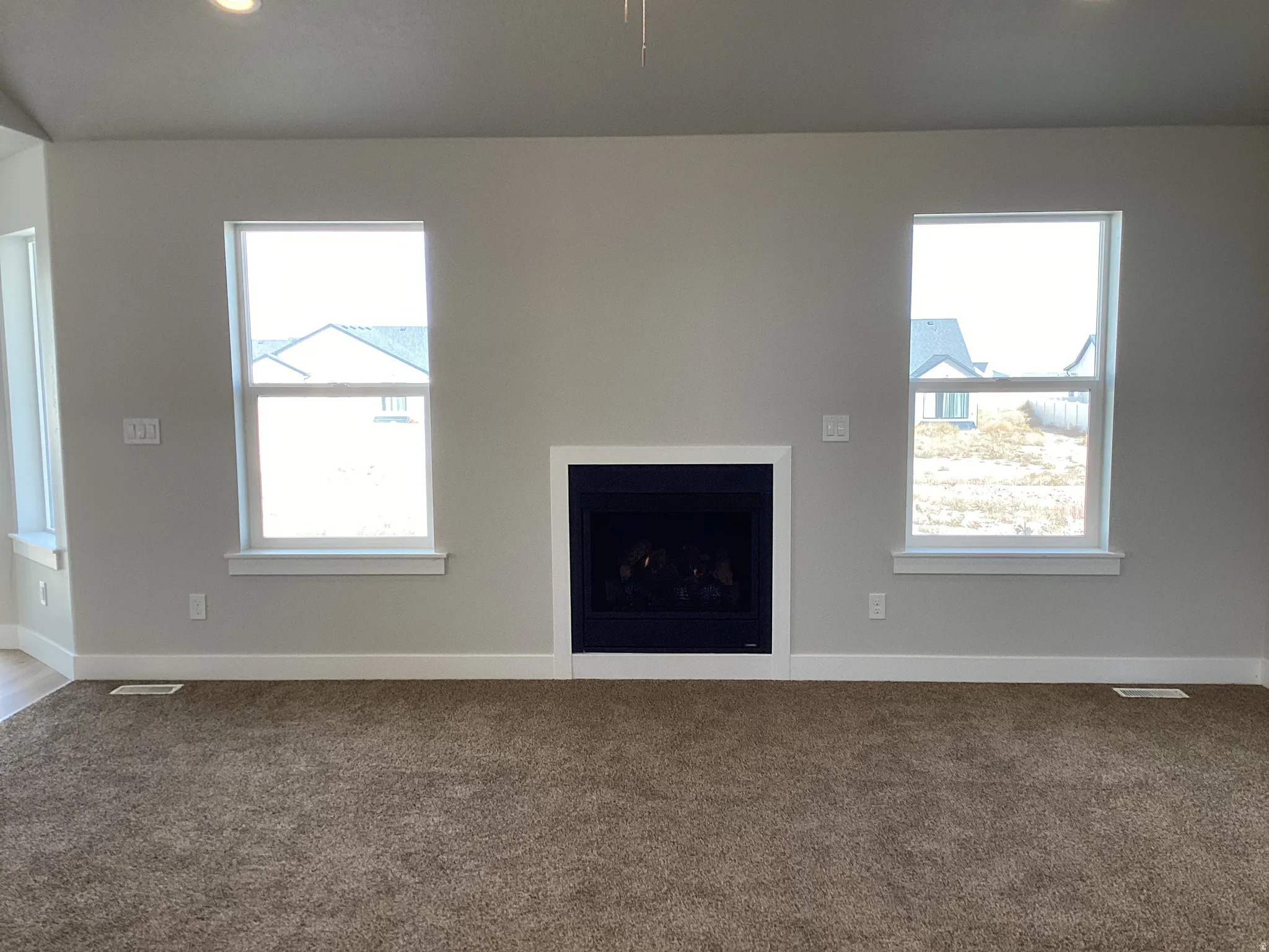 Unfurnished living room with a fireplace, carpet flooring, and recessed lighting